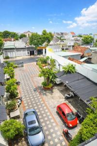 two cars are parked in a parking lot at Window 2 Hotel in Kon Tum +33 photos