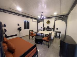 a room with a bed and a table and chairs at Nomada in Mount Ābu