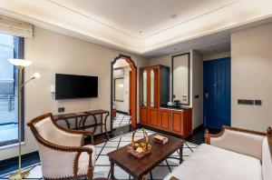 a living room with a couch and a table at Acacia Somgarh Udaipur in Udaipur