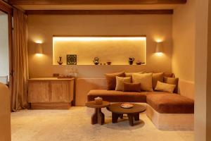 a living room with a couch and a table at Kumbara Oasis Lombok in Kuta Lombok +50 photos
