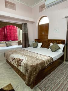 a bedroom with two beds and a window at The Rajputana Heritage in Jodhpur