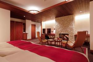 a bedroom with a large bed and a fireplace at Hotel Chourakukan Kyoto Gion in Kyoto +156 photos