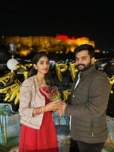 a man and a woman holding a bouquet of flowers at The Rajputana Heritage in Jodhpur