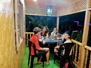 a group of people sitting around a table in a restaurant at ABBA'S homestay in Srinagar