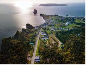 an aerial view of a road next to the ocean at En Route Vers l'Infini in Perce