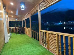 a balcony with a view of the water at night at ABBA'S homestay in Srinagar +8 photos