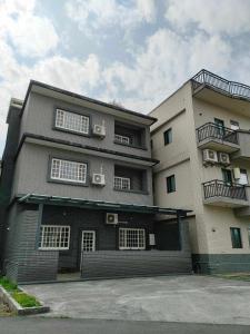 a large building with windows and balconies on it at Lan Cheng Su in Yuanshan