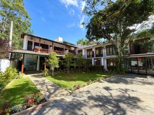 an exterior view of a building with a courtyard at Ella Inn in Ella +25 photos