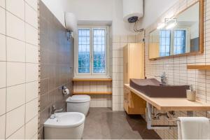 a bathroom with a toilet and a sink and a mirror at Vacanze Romane con giardino in Rome