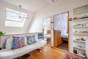 a living room with a white couch and a mirror at Sapporoの実家 B&B Yoshida in Sapporo