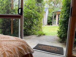 a door to a bedroom with a sign in the doorway at Te Anau Lakefront Backpackers in Te Anau