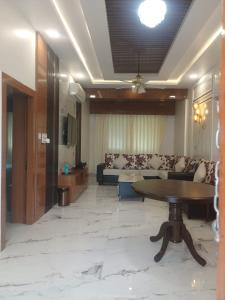 a living room with a couch and a table at Indo Hokke Hotel in Rājgīr