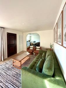 a living room with a large green couch at Beach Paradise- 4 Min Walk To Beach in Santa Cruz