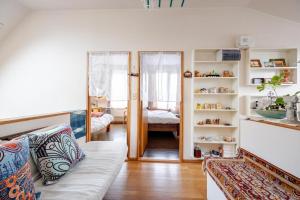 a living room with a couch and a mirror at Sapporoの実家 B&B Yoshida in Sapporo