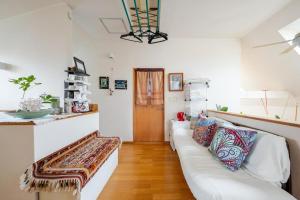 a living room with a white couch with pillows at Sapporoの実家 B&B Yoshida in Sapporo +65 photos