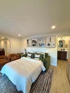 a bedroom with a large bed and a couch at Beach Paradise- 4 Min Walk To Beach in Santa Cruz