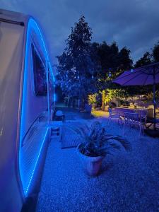 a van parked in a yard at night at TheBoxCaravan in Ban Pak Ram
