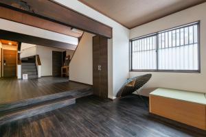 a living room with a large window and a chair at 開港庵 in Hakodate