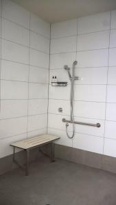 a shower stall with a bench in a room at Gallery Boutique Hotel in Fremantle