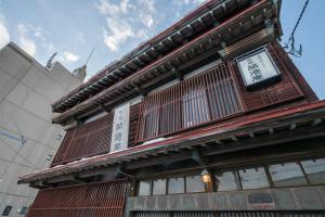 a building with a clock on the side of it at 開港庵 in Hakodate