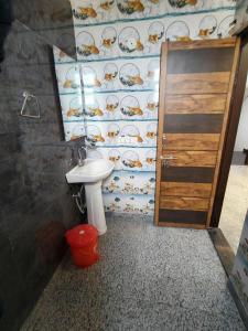 a bathroom with a toilet and a sink and a door at RSR event service in Faridabad