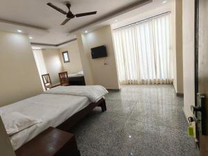 a bedroom with a bed and a ceiling fan at RSR event service in Faridabad +14 photos