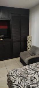 a room with a zebra print bed in a room at Casa tabachin in Arandas +2 photos