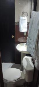 a bathroom with a white toilet and a sink at Casa tabachin in Arandas