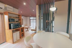 a living room with a white table and chairs at The Nature Uno 2026年リノベーション 直島好アクセス 古民家一棟貸切 最大4名2ldk平家 クイーンベッド2台 in Tamano