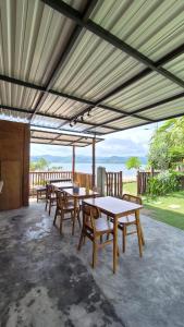 a group of tables and chairs on a patio at Yellow Coco Gili Gede in Gili Gede