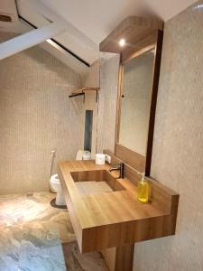 a bathroom with a wooden sink and a mirror at 7 Day Inn in Gili Trawangan