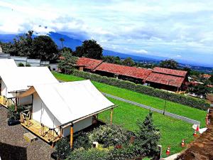 an overhead view of a group of buildings with white roofs at D Royale Tapos Resort Bogor in Tapos