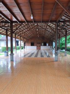 a large hall with a wooden ceiling and a wooden floor at D Royale Tapos Resort Bogor in Tapos