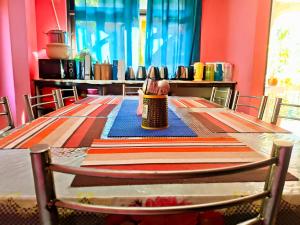 a table with a person sitting on top of it at Aurora Farmstay in Rongli