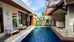 a swimming pool in the backyard of a villa at Emstaliese & Palmarosa Villas Seminyak in Legian