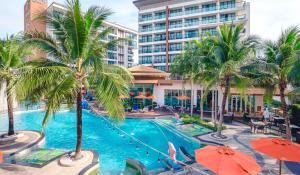 an image of a resort swimming pool with palm trees at Stay Kata in Kata Beach