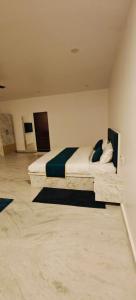 a bedroom with a large bed with blue pillows at The Jungle Gate Villa in Udaipur