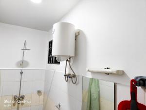 a white bathroom with a light on the wall at Twiga Luxe in Arusha