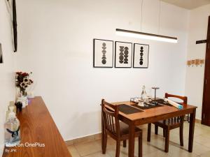 a dining room with a wooden table and two chairs at Twiga Luxe in Arusha