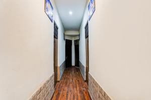 a hallway of a building with wooden floors at Hotel O George Town in Colonelganj