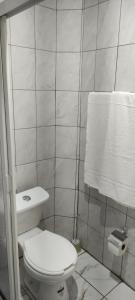 a white bathroom with a toilet and a towel at Kahjú Arandas Depa in Arandas +12 photos