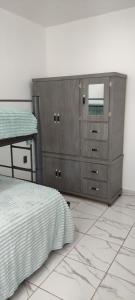 a bedroom with a dresser with a mirror and a bed at Kahjú Arandas Depa in Arandas