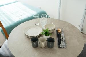 a table with plates and glasses on top of it at Nagomi Apartment Hotel in Hatsukaichi +20 photos