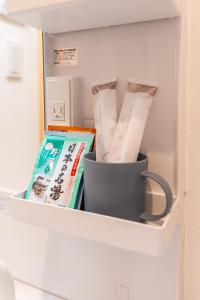 a drawer in a refrigerator with a container of food at Nagomi Apartment Hotel in Hatsukaichi