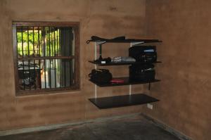 a room with shelves on a wall next to a window at Panthera Lodge Yala in Kirinda