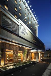 a building with a sign on the side of it at Toyooka Green Hotel Morris in Toyooka