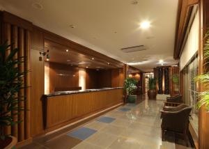 a lobby with a bar with plants in it at Toyooka Green Hotel Morris in Toyooka +35 photos