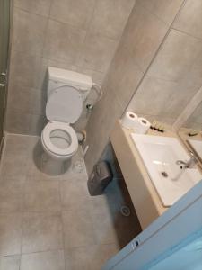 a bathroom with a toilet and a sink at אלמוגי אוראל in Eilat