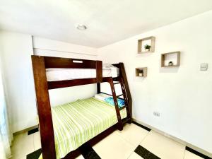 a small room with two bunk beds in it at Comfort House in Lima