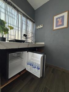 an open refrigerator with water bottles in it at Tequisquiapan Encantó in San Nicolás